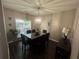 Bright dining room featuring modern light fixture and dark dining set at 127 Spring Way Sq, Canton, GA 30114