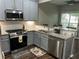 Modern kitchen featuring stainless steel appliances, granite countertops, subway tile, and lots of natural light at 127 Spring Way Sq, Canton, GA 30114