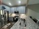 Charming kitchen with granite countertops, stainless steel appliances and light blue cabinets at 127 Spring Way Sq, Canton, GA 30114