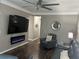 Elegant living room with a large TV and sleek electric fireplace at 127 Spring Way Sq, Canton, GA 30114