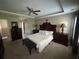 Spacious main bedroom suite featuring a decorative tray ceiling, neutral carpeting, and elegant bedroom furniture at 127 Spring Way Sq, Canton, GA 30114