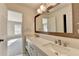 Bathroom with dual sinks, custom mirror, and bright lighting at 1723 Woodbow Path, Dacula, GA 30019