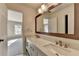Bathroom with dual sinks, custom mirror, and bright lighting at 1723 Woodbow Path, Dacula, GA 30019