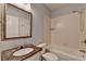 A full bathroom featuring a toilet, marble vanity, mirror, and bathtub with a shower at 1723 Woodbow Path, Dacula, GA 30019