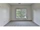 Cozy bedroom features a large window offering natural light and exterior views at 1723 Woodbow Path, Dacula, GA 30019