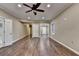 Hardwood bedroom with ceiling fan and double doors at 1723 Woodbow Path, Dacula, GA 30019