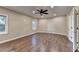 Spacious bedroom with hardwood floors, fan, and natural lighting at 1723 Woodbow Path, Dacula, GA 30019