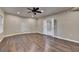 Hardwood bedroom with ceiling fan and double doors at 1723 Woodbow Path, Dacula, GA 30019