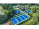 An aerial photo of the community's tennis courts features multiple courts with blue surfaces at 1723 Woodbow Path, Dacula, GA 30019
