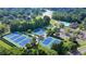 A beautiful aerial view showcases the community's tennis courts, pool, and lake at 1723 Woodbow Path, Dacula, GA 30019