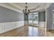 Dining room featuring hardwood floors, a modern chandelier, and large bay window at 1723 Woodbow Path, Dacula, GA 30019