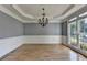 Formal dining room with hardwood floors, wainscoting and chandelier lighting at 1723 Woodbow Path, Dacula, GA 30019