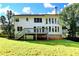 The backyard view shows a white two-story house with a well-manicured lawn and treelined backdrop at 1723 Woodbow Path, Dacula, GA 30019