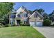 Charming brick two-story home with manicured lawn and attached two-car garage in a desirable neighborhood at 1723 Woodbow Path, Dacula, GA 30019