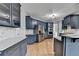 Open kitchen with stainless appliances, island with breakfast bar, and marble backsplash at 1723 Woodbow Path, Dacula, GA 30019