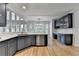 Well-lit kitchen with dark blue cabinets, marble countertops, stainless steel appliances, and hardwood floors at 1723 Woodbow Path, Dacula, GA 30019