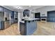 Spacious kitchen with stainless appliances and a view into the living room with fireplace at 1723 Woodbow Path, Dacula, GA 30019