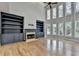 Open living room features a fireplace, built-in shelving, and a wall of large windows at 1723 Woodbow Path, Dacula, GA 30019