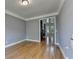 Living room featuring hardwood floors, a modern chandelier, and large bay window at 1723 Woodbow Path, Dacula, GA 30019