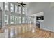 Spacious living area with large windows, hardwood floors, and a wet bar at 1723 Woodbow Path, Dacula, GA 30019