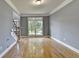Open living room area featuring hardwood floors, staircase and large bay window at 1723 Woodbow Path, Dacula, GA 30019