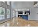 Open concept living room with tall windows and a view into the modern kitchen at 1723 Woodbow Path, Dacula, GA 30019