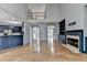 Sunlit living room with fireplace and a view into the modern kitchen and upper floor landing at 1723 Woodbow Path, Dacula, GA 30019