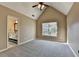 Carpeted main bedroom with vaulted ceiling features a window and en-suite bathroom access at 1723 Woodbow Path, Dacula, GA 30019