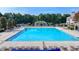 A luxurious community pool with lounge chairs is seen in this real estate listing photograph at 1723 Woodbow Path, Dacula, GA 30019