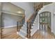 View of staircase with hardwood floors, and wrought iron balusters at 1723 Woodbow Path, Dacula, GA 30019