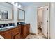 Bathroom with granite countertops, double sinks, wooden cabinets, and a view to the toilet and shower at 350 Lamplighter Se Ln, Marietta, GA 30067