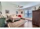 Cozy bedroom featuring hardwood floors, a ceiling fan, a patterned rug, and a bright window at 350 Lamplighter Se Ln, Marietta, GA 30067