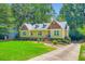 Charming home features a well-manicured lawn and inviting entrance with brick steps at 350 Lamplighter Se Ln, Marietta, GA 30067