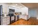Updated kitchen featuring stainless steel appliances, white cabinetry, and hardwood floors at 350 Lamplighter Se Ln, Marietta, GA 30067