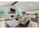 Spacious living room with white brick fireplace, hardwood floors, and access to the deck at 350 Lamplighter Se Ln, Marietta, GA 30067