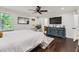A well-lit main bedroom featuring hardwood floors, a ceiling fan, a TV, and views to the bathroom at 350 Lamplighter Se Ln, Marietta, GA 30067