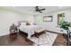 Bright main bedroom featuring hardwood floors, a ceiling fan, and windows that offer natural light and an outdoor view at 350 Lamplighter Se Ln, Marietta, GA 30067