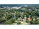 Expansive aerial view of home in a lush neighborhood with community pool, lake and mature trees at 4063 Penhurst Dr, Marietta, GA 30062
