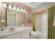 Well-lit bathroom featuring patterned wallpaper, shower-tub combo, and single sink vanity at 4063 Penhurst Dr, Marietta, GA 30062