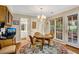Sunny breakfast nook features hardwood floors and large windows offering views of the outdoor patio at 4063 Penhurst Dr, Marietta, GA 30062