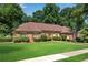Charming brick home featuring lush green lawn, mature landscaping, and inviting curb appeal at 4063 Penhurst Dr, Marietta, GA 30062