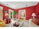 Cozy living room with bright red walls, with natural light and view of dining room at 4063 Penhurst Dr, Marietta, GA 30062