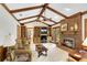 Cozy living room with exposed beams, fireplace, built-in bookcases, and ample seating at 4063 Penhurst Dr, Marietta, GA 30062
