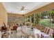 Enclosed porch featuring a ceiling fan and a variety of seating options with a view of the yard at 4063 Penhurst Dr, Marietta, GA 30062