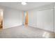 Bright bedroom featuring neutral carpet, an open doorway, and a double closet at 4601 Lindsey Dr, Powder Springs, GA 30127
