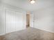 Bedroom featuring neutral carpeting, a double closet, and an open doorway at 4601 Lindsey Dr, Powder Springs, GA 30127