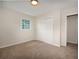 Inviting bedroom featuring a large double closet, neutral carpet, and a bright window at 4601 Lindsey Dr, Powder Springs, GA 30127