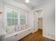 Bright breakfast nook with window seat and storage, featuring wood flooring and neutral decor at 4601 Lindsey Dr, Powder Springs, GA 30127