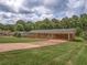 Wide shot of a single-story brick home with an attached carport and circular driveway at 4601 Lindsey Dr, Powder Springs, GA 30127