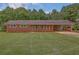 Charming red brick home with covered carport and beautifully manicured lawn at 4601 Lindsey Dr, Powder Springs, GA 30127